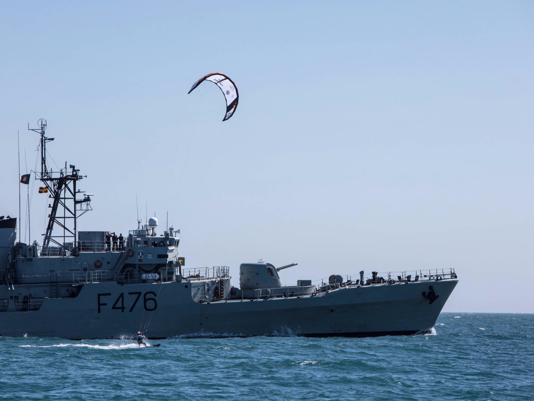 Lufinha kitesurfing besides Portuguese navy ship
